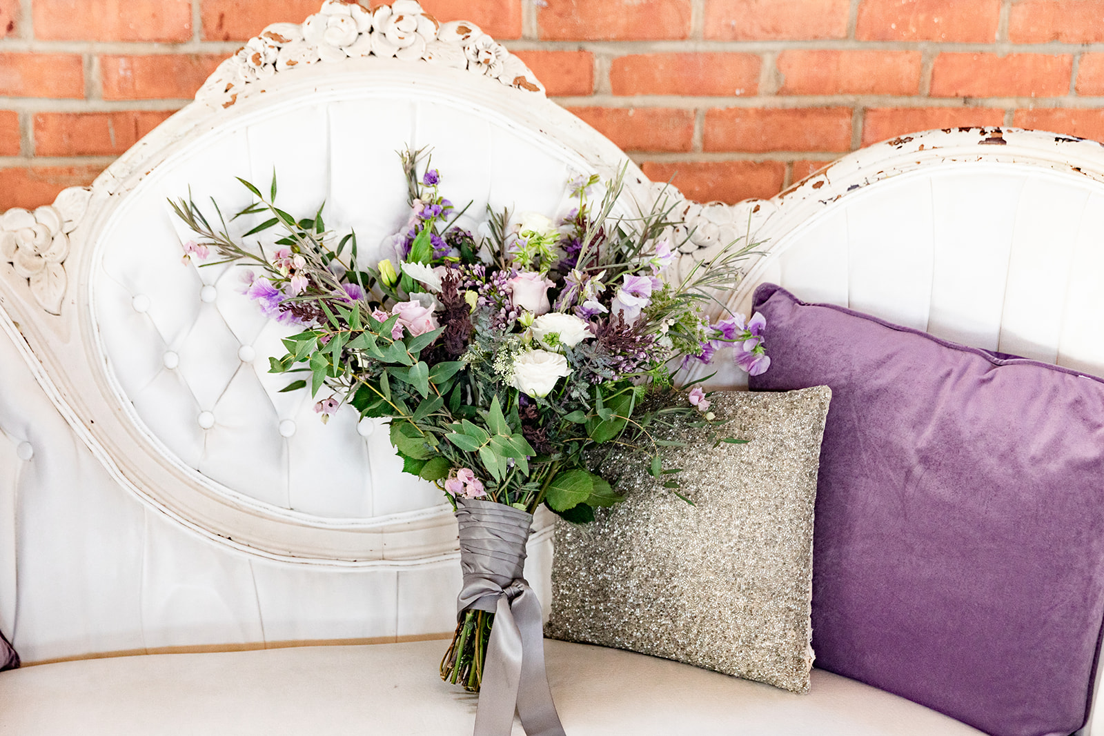 wedding bouquet on white couch