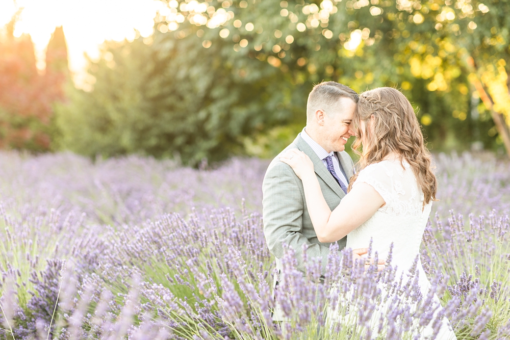 bride and groom slow dancing in lavender field during golden hour sunset